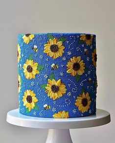 a blue and yellow cake with sunflowers on it