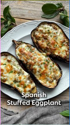 three stuffed eggplant on a white plate with the title spanish stuffed eggplant