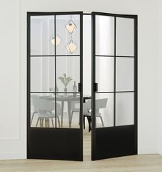 an open glass door leading into a dining room