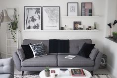 a living room filled with furniture and pictures on the wall above it's coffee table