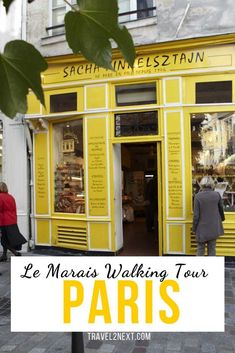 a yellow building with the words le maras walking tour paris