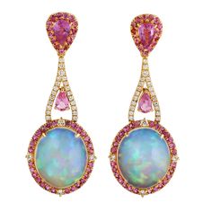 Cast in 14 karat gold. These earrings are hand set in 9.15 carats Ethiopian opal, 2.5 carats pink sapphire and .38 carats of sparkling diamonds. Matching ring available. FOLLOW MEGHNA JEWELS storefront to view the latest collection & exclusive pieces. Meghna Jewels is proudly rated as a Top Seller on 1stDibs with 5 star customer reviews. All items manufactured by us are handmade and can be customized or redesigned. Composition Size-42X16 MM Total Weight-8.778 Gold Weight(Gms)-6.371 Diamond Wt(Ct Hallmarked Pink Fine Jewelry Earrings, Luxury Pink Opal Round Jewelry, Luxury Yellow Gold Pink Sapphire Earrings, Luxury Pink Sapphire Earrings, Pink Multi-stone Earrings In Fine Jewelry Style, Opal Earring, Dkny Bag, Shiny Rings, Vintage Drop Earrings