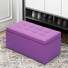 a purple ottoman sitting on top of a rug in front of a shoe rack with shoes