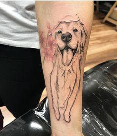 a black and white photo of a dog's face on the arm with flowers around it