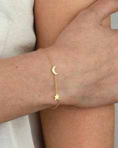 The Moon + Star Bracelet by Tashi is a celestial bracelet that adds starshine to your wrist. 14k gold vermeil Length: Adjustable 6.5"-7" Star Moon Bracelet, Simple Bracelets Gold, Bracelet Ideas Gold, Hand Bracelet Gold, Moon And Stars Bracelet