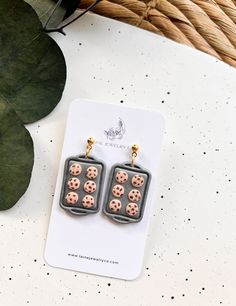 a pair of earrings with chocolate chip cookies on them