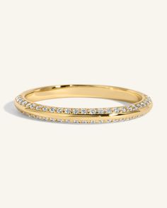 a yellow gold ring with rows of diamonds