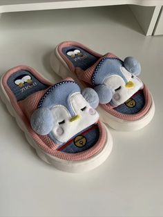 a pair of slippers with cartoon characters on them