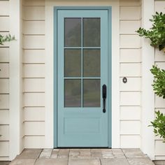 a blue front door on a white house