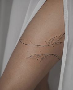 a woman's arm with a tattoo on it that has an arrow in the middle