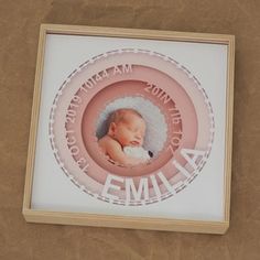 a baby's birth announcement is displayed in a frame on the side of a wall