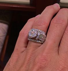 a woman's hand with two diamond rings on it