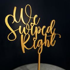 a gold cake topper with the words we survived right on it in cursive writing