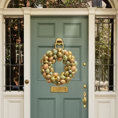 a green door with a wreath on it