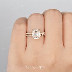 a woman's hand with an engagement ring on it