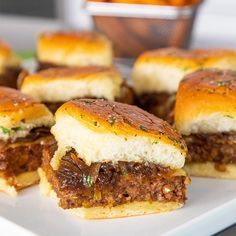 mini sandwiches with meat and cheese are on a plate