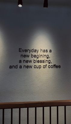 there is a sign on the wall that says everyday has a new beginning and a new cup of coffee