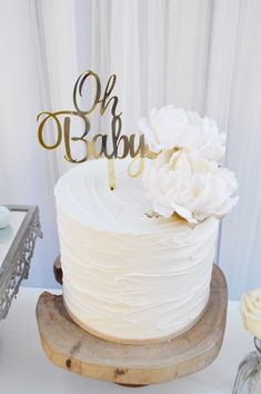 a white cake sitting on top of a wooden stand