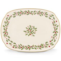 an oval platter with holly and berries on it