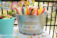 a bucket full of candy sticks sitting on top of a table