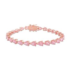 Express your playful style with this sweet pear-shaped pink lab-created sapphire tennis bracelet. Fashioned in sterling silver with rose rhodium plate This design glistens with a vibrant row of sideways 6.0 x 4.0mm pear-shaped bright pink lab-created sapphires. This choice adds attention-grabbing color to your attire. The 7.25-inch bracelet secures with a tongue and groove clasp. Luxury Pink Tennis Bracelet For Women, Luxury Pink Tennis Bracelet, Adjustable Pink Tennis Bracelet, Formal Pink Gemstone Tennis Bracelet, Pink Cubic Zirconia Tennis Bracelet, Fine Jewelry, Apple Watch Bands Women, Rose Bracelet, Pink Accessories, Peoples Jewellers