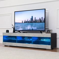 a flat screen tv sitting on top of a entertainment center