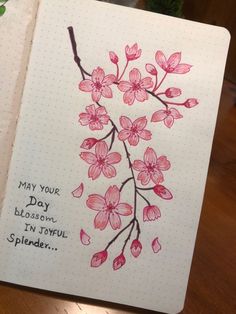 an open notebook with pink flowers on it