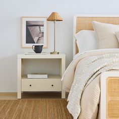 a bedroom with a bed, nightstand and pictures on the wall