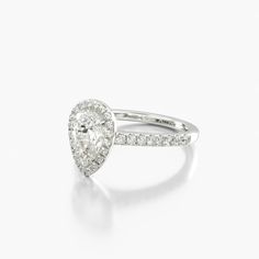 a pear shaped diamond ring on a white background