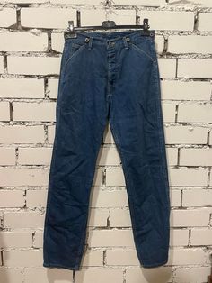 These vintage Lee Boss of the Road 88 jeans from the 60s are a must-have for any denim enthusiast. The classic blue color and regular style make them perfect for any occasion. The denim fabric type ensures durability and comfort, while the size of 32/34 fits most men. The Lee brand has been a trusted name in fashion for years, and these jeans are no exception. The size type is regular, and the inseam and size can be seen in the pictures. These jeans are an excellent addition to any wardrobe and Vintage Mid-rise Pants For Streetwear, Retro Washed Blue Straight Leg Jeans, Vintage Denim Blue Streetwear Pants, Retro Medium Wash Jeans With Pockets, Retro Denim Blue Cotton Jeans, Retro Blue Jeans With Pockets, Retro Medium Wash Cotton Jeans, Classic Pre-washed Denim Blue Jeans, Retro Washed Blue Rigid Denim Jeans