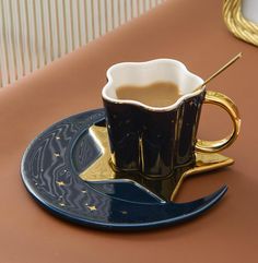 a coffee cup on a saucer with a spoon in it sitting on a plate