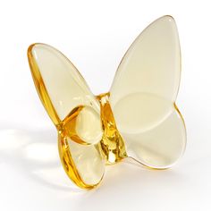 a butterfly shaped glass object sitting on top of a white surface with its wings open