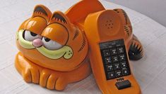 an orange cat phone sitting on top of a table