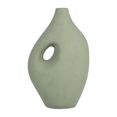 a light green vase with an oval hole in the middle on a white background,