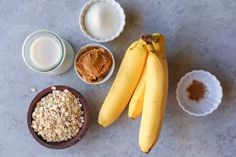 bananas, oatmeal, and peanut butter are on the table next to each other