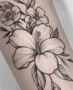 a black and white flower tattoo on the leg