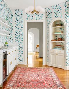 the hallway is decorated with blue and white wallpaper