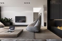 a modern living room with fireplace, couch and coffee table in front of the tv