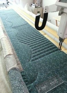 an image of a machine that is cutting fabric on the floor with it's blades