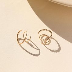 Love our Mini Twists but want to add a little flare?! Check out the Spiral Twists! These effortless earrings slide through a single ear hole, giving the illusion of a second piercing with a literal twist! Featuring a spiral warp this twist is an elevated take on a classic piece. DETAILS The hoops measure 14-16mm.Choose from 14k Gold Fill or Sterling SilverHypoallergenic, nickel-free and water safe Second Piercing, Mini Twists, Personalized Jewelry, Gold Filled, Everyday Fashion, Twist, Handmade Jewelry, Jewelry Making, Sterling Silver