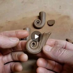 two hands are working on an object that looks like a spiral doorknott