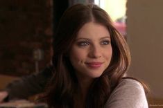 a beautiful young woman sitting at a table