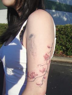 a woman with a flower tattoo on her arm