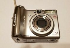 a silver digital camera sitting on top of a table