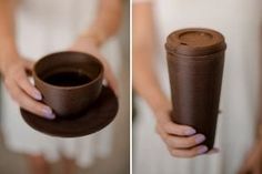 a woman holding a coffee cup in one hand and a chocolate cup in the other