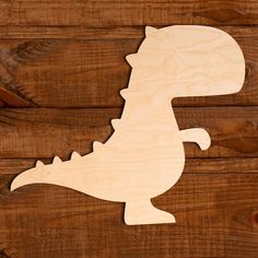 a wooden cutout of a dinosaur