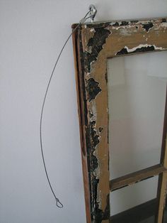 an old window frame hanging on the wall