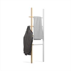 a coat rack with two coats hanging from it's sides and a towel on the back