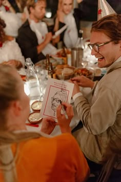 a group of people sitting around a dinner table