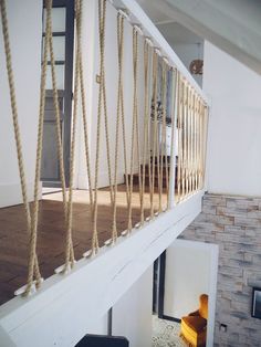 there is a stair case with rope hanging from it